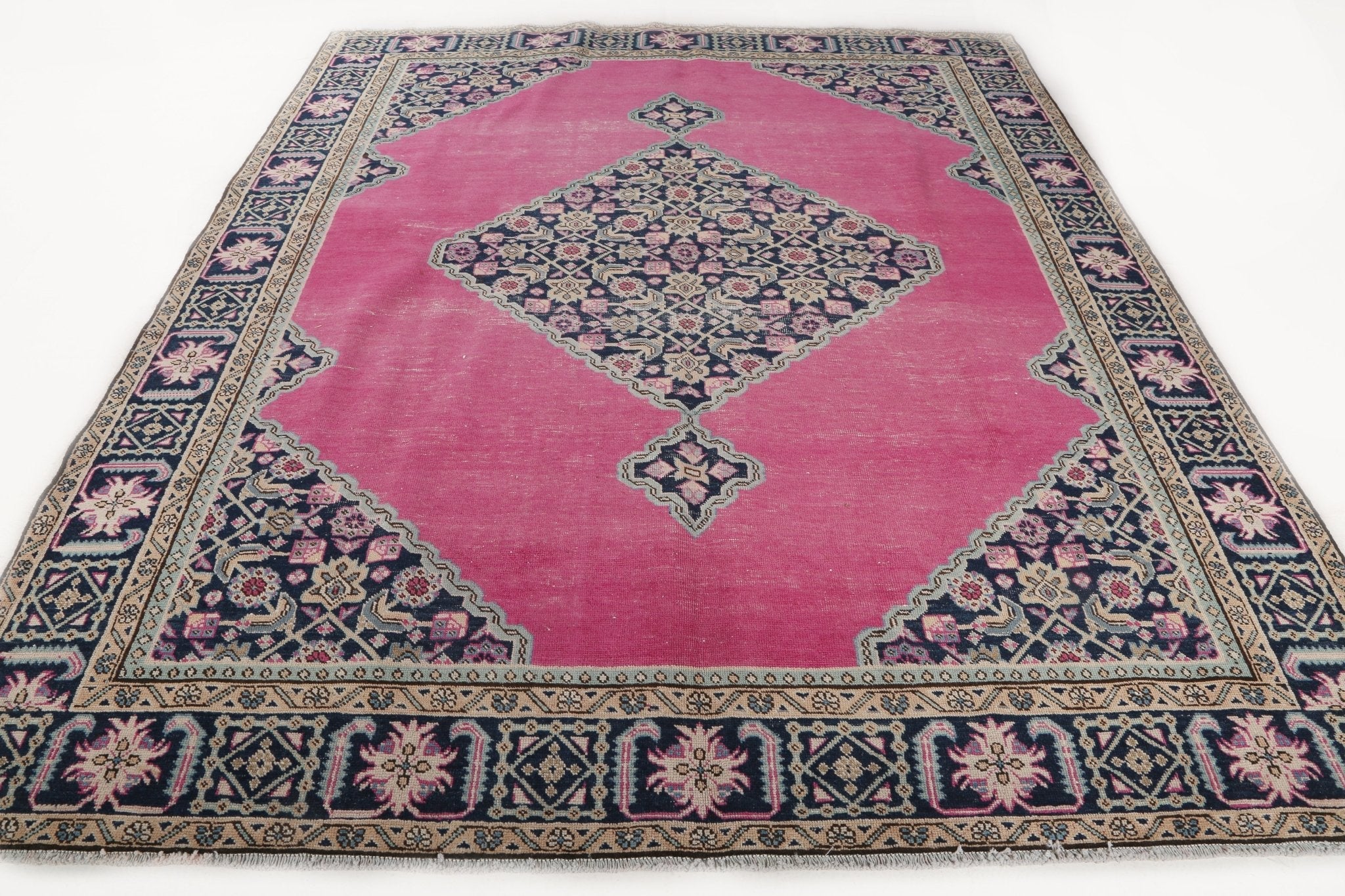 Persian Ardabil rug with pink center panel, navy corner motifs, and detailed border