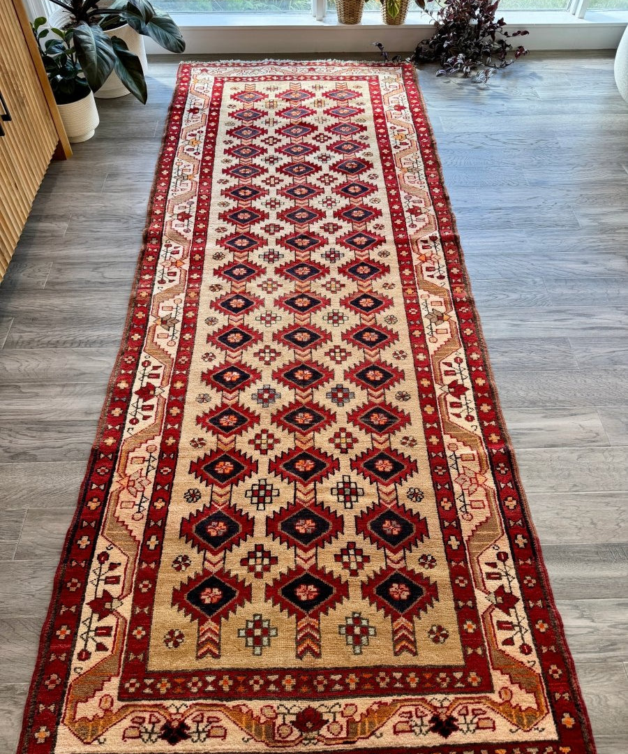 Persian Azerbaijan runner rug, red border and cream center with navy repeating diamond pattern