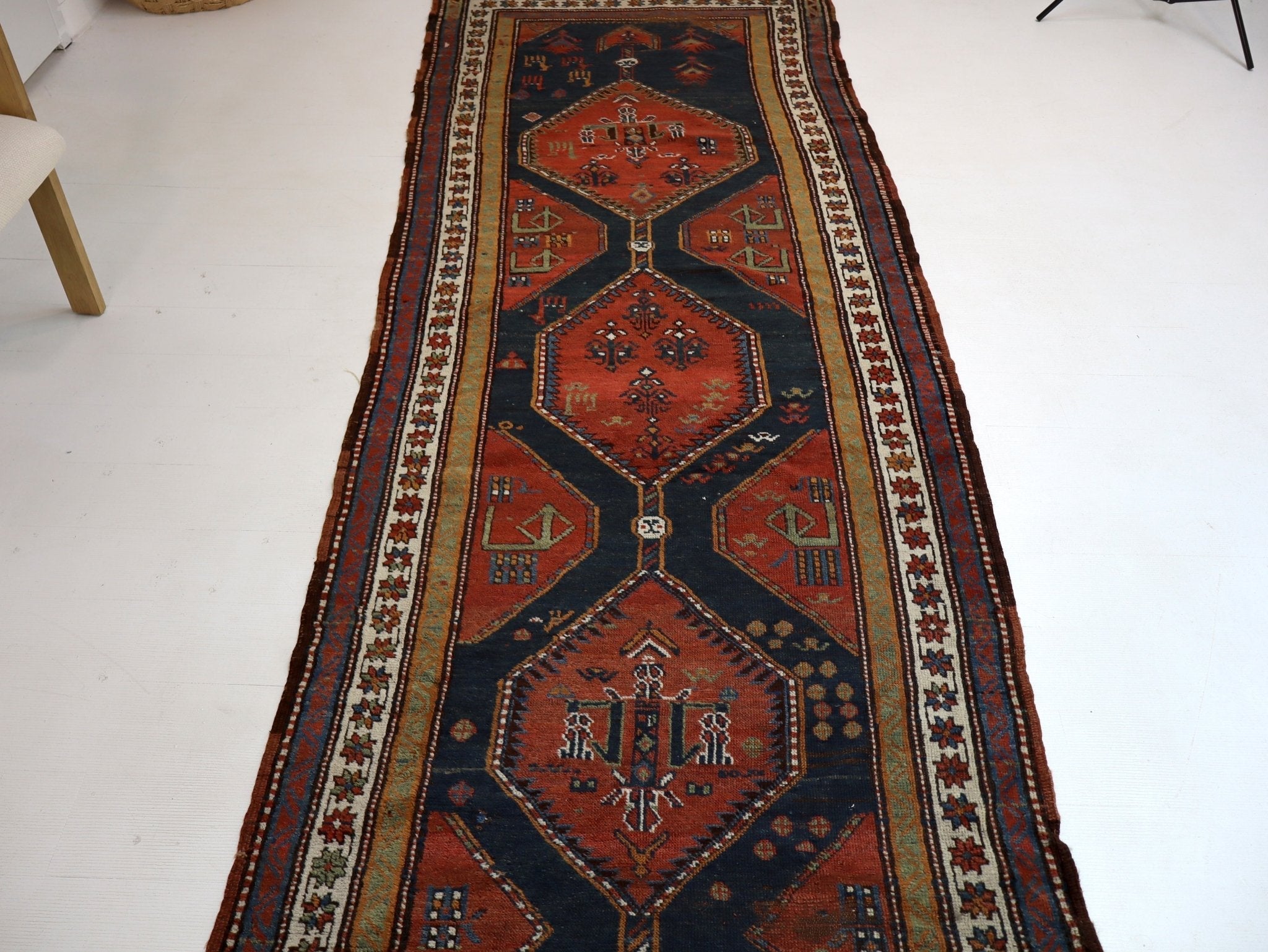 Persian runner rug section, dark navy and rust with central medallion and border motifs