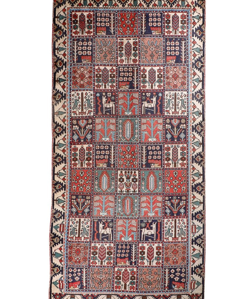 Persian Bakhtiar rug with red, blue, and ivory geometric medallion border.