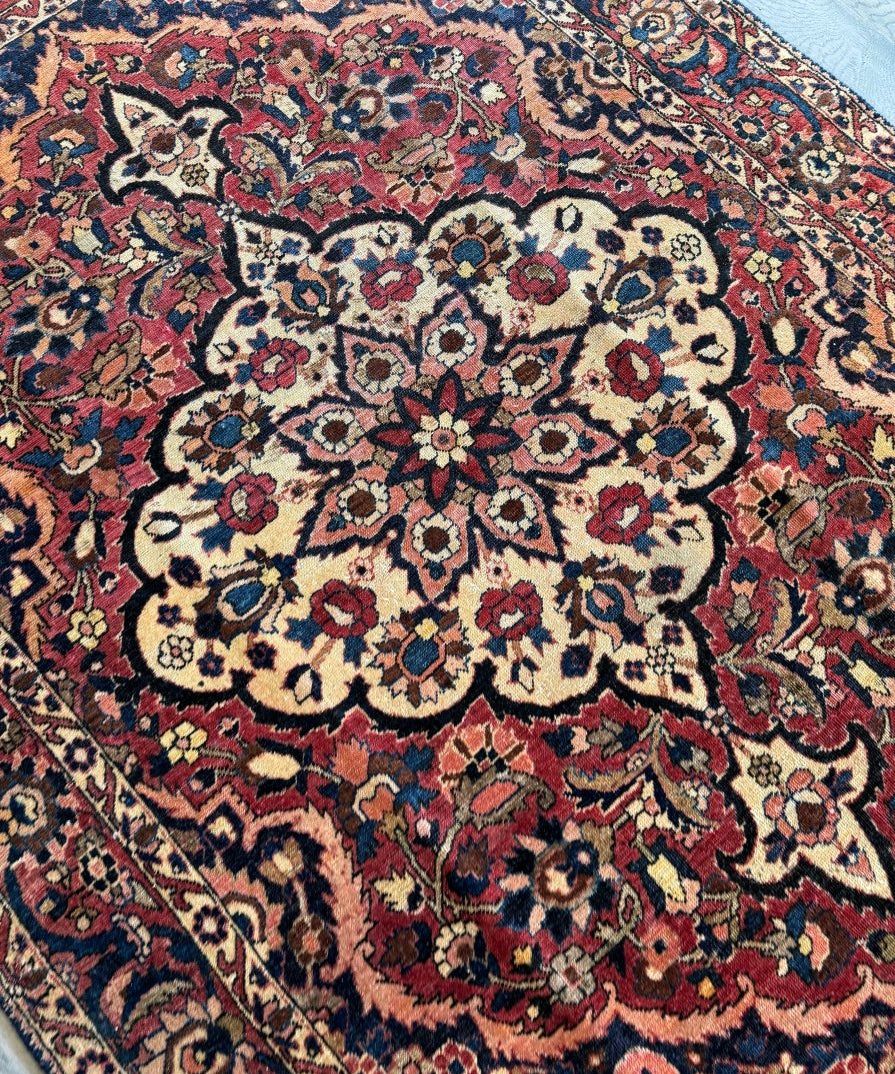 Persian Bakhtiar rug close-up of central cream medallion with red and navy vines