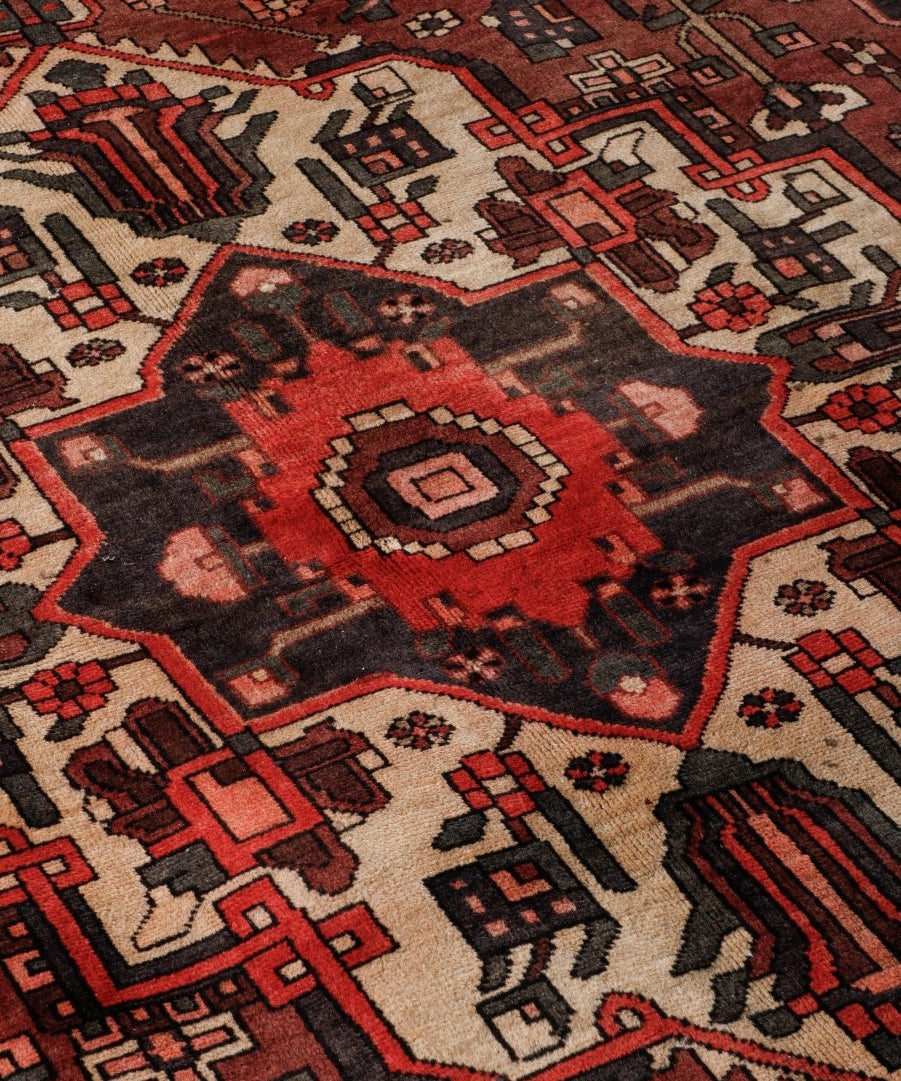 Persian Bakhtiar rug with central medallion and multicolor geometric pattern in red