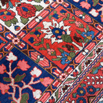 Persian Bakhtiari rug diagonal close-up with red, blue, green, and ivory floral patterns