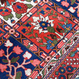 Persian Bakhtiari rug diagonal close-up with red, blue, green, and ivory floral patterns