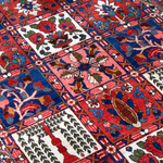 Persian Bakhtiari rug top view with red-blue lattice blocks and ivory accent medallions