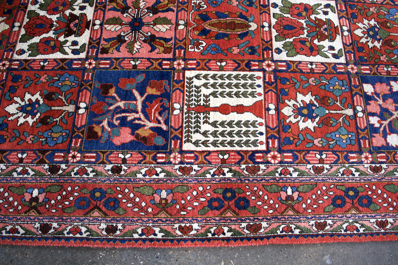Persian Bakhtiari rug with red, blue, and white floral geometric border details