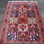 Persian Bakhtiari rug with red field and central medallion in blue and cream