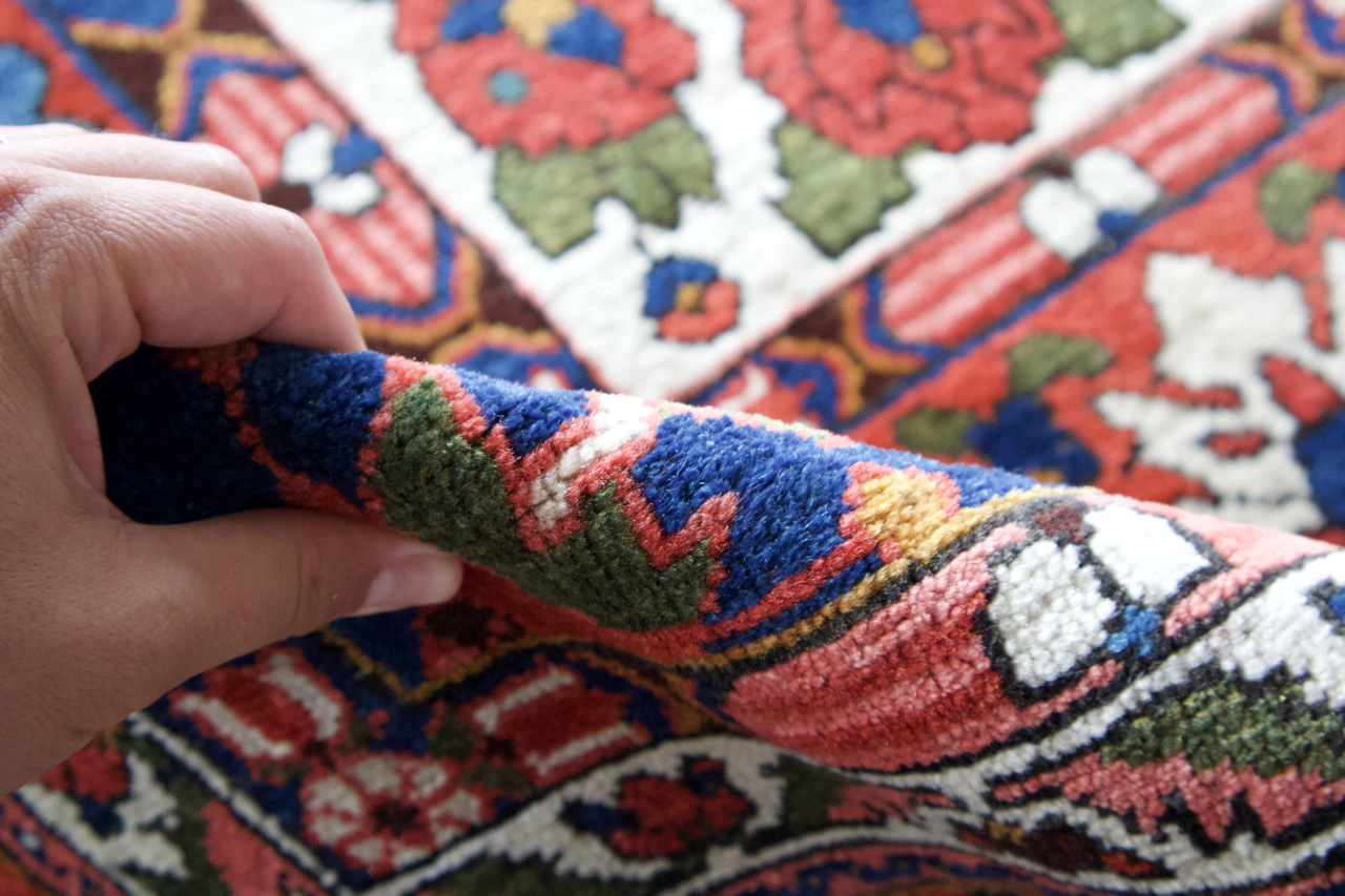 Persian Bakhtiari rug corner with multicolor geometric motifs and hand-knotted fringe