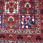 Persian Bakhtiari rug border section with red and blue tiles plus floral center motifs