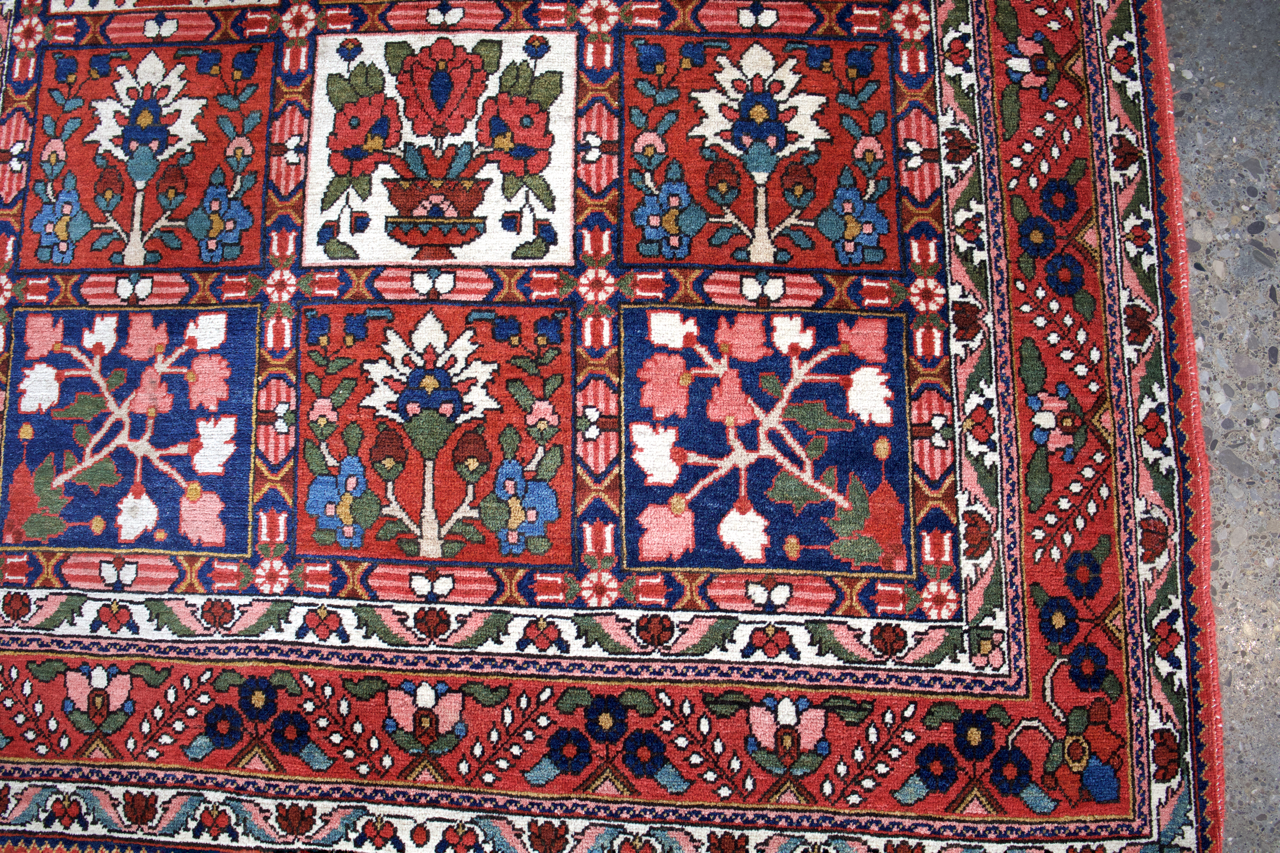 Persian Bakhtiari rug border section with red and blue tiles plus floral center motifs