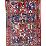 Persian Bakhtiari rug featuring a blue-red central medallion and patterned border