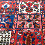 Persian Bakhtiari rug close-up of floral and star motifs in red, blue, and green