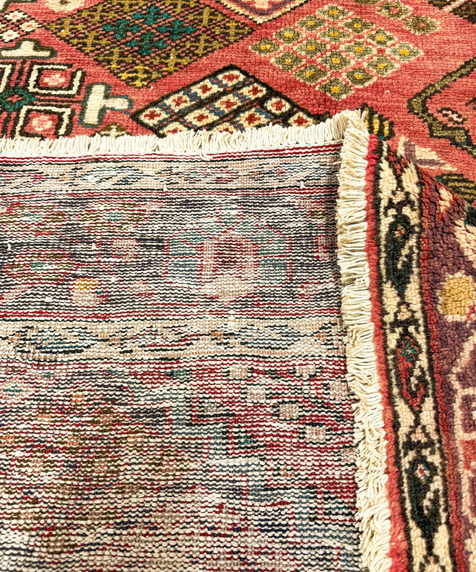 Bakhtiari rug fringe detail with off-white and red woven border