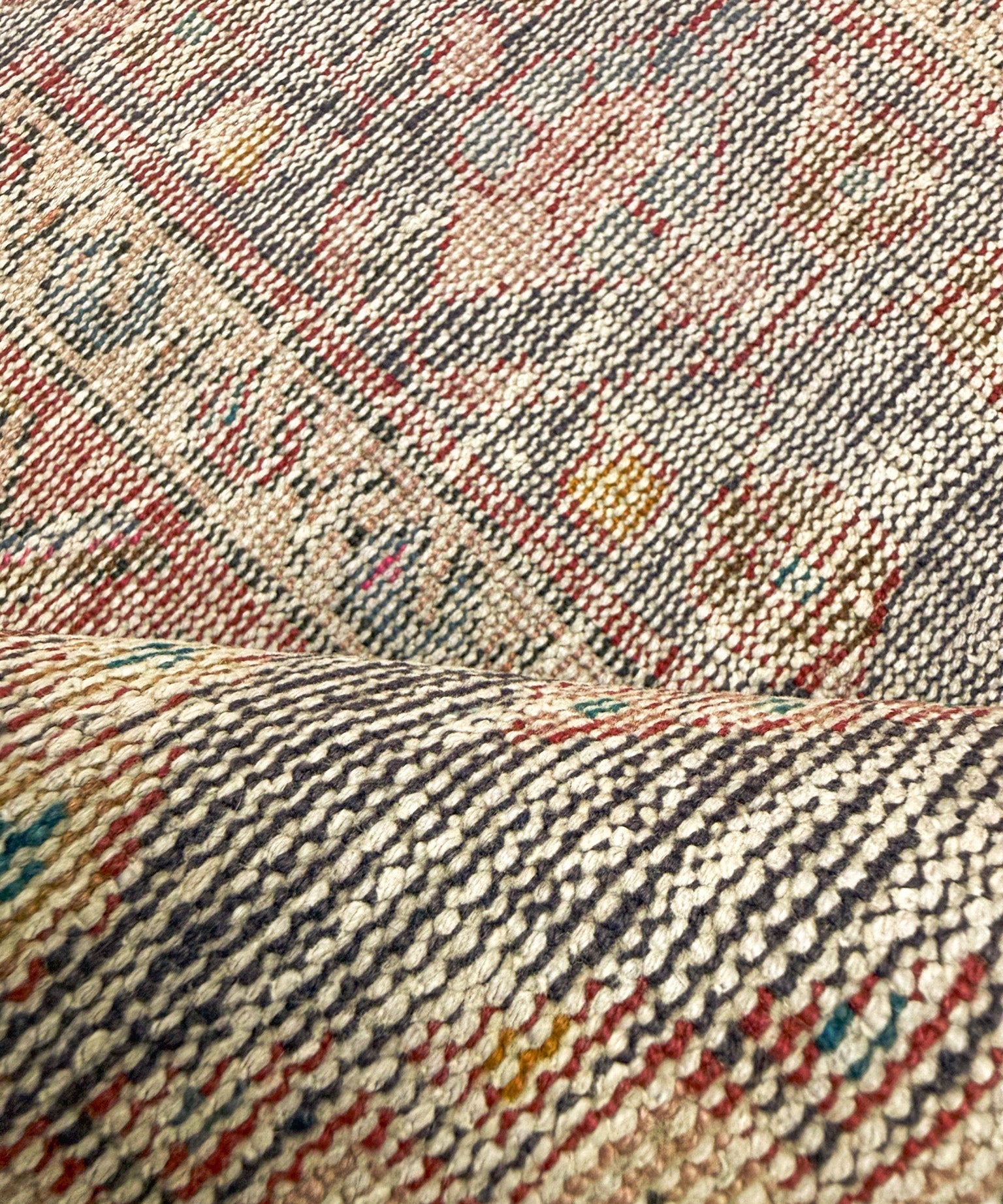 Bakhtiari rug close-up of woven pile with beige, gray, and red pattern lines