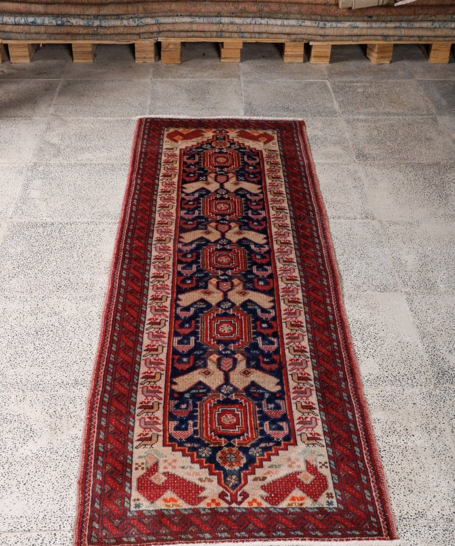 Persian Baluch runner rug, red and navy with cream field and repeating medallions