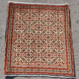Small Persian Bidjar rug square with cream center, red border, and ornate medallion pattern.