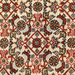 Persian Bidjar rug surface close-up with cream ground and repeating flower-and-lattice motifs.