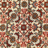 Persian Bidjar rug surface close-up with cream ground and repeating flower-and-lattice motifs.