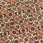 Persian Bidjar rug texture close-up with cream background and red-orange geometric motifs.
