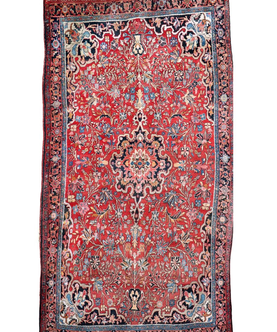 Red Persian-style rug with ornate central medallion, blue frame border, flat lay