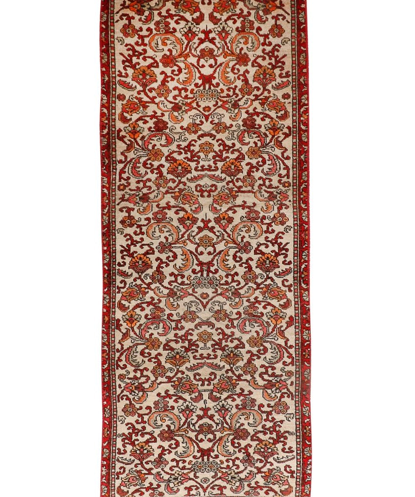 Persian Bidjar runner rug with cream field, red border, and ornate red medallion pattern.