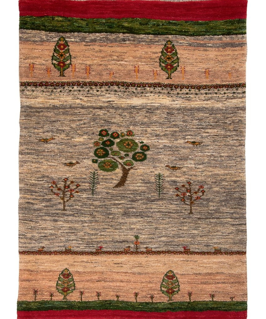 Persian Gabbeh rug flat-lay with tree motif, green and red bands, and short fringe edges