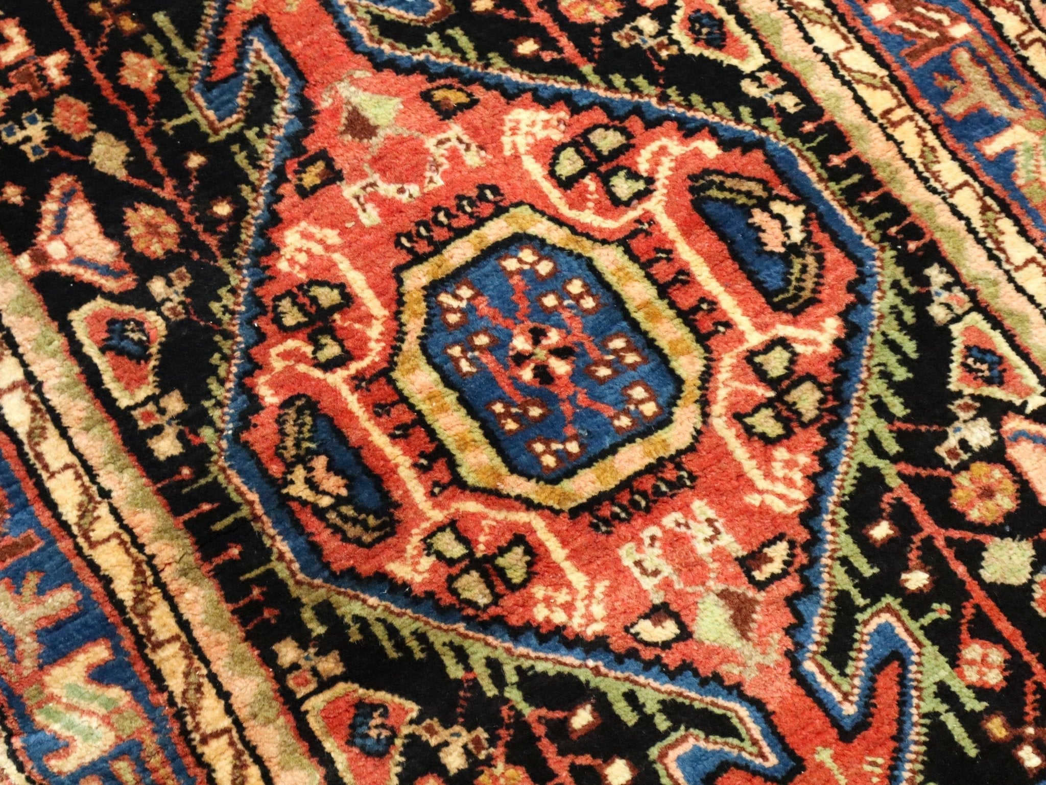 Persian Hamadan rug close-up of blue square medallion in red and cream