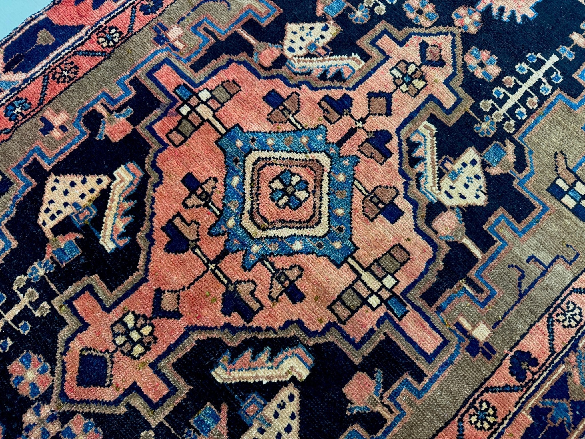 Hamadan rug close-up of central medallion in pink, blue, and cream