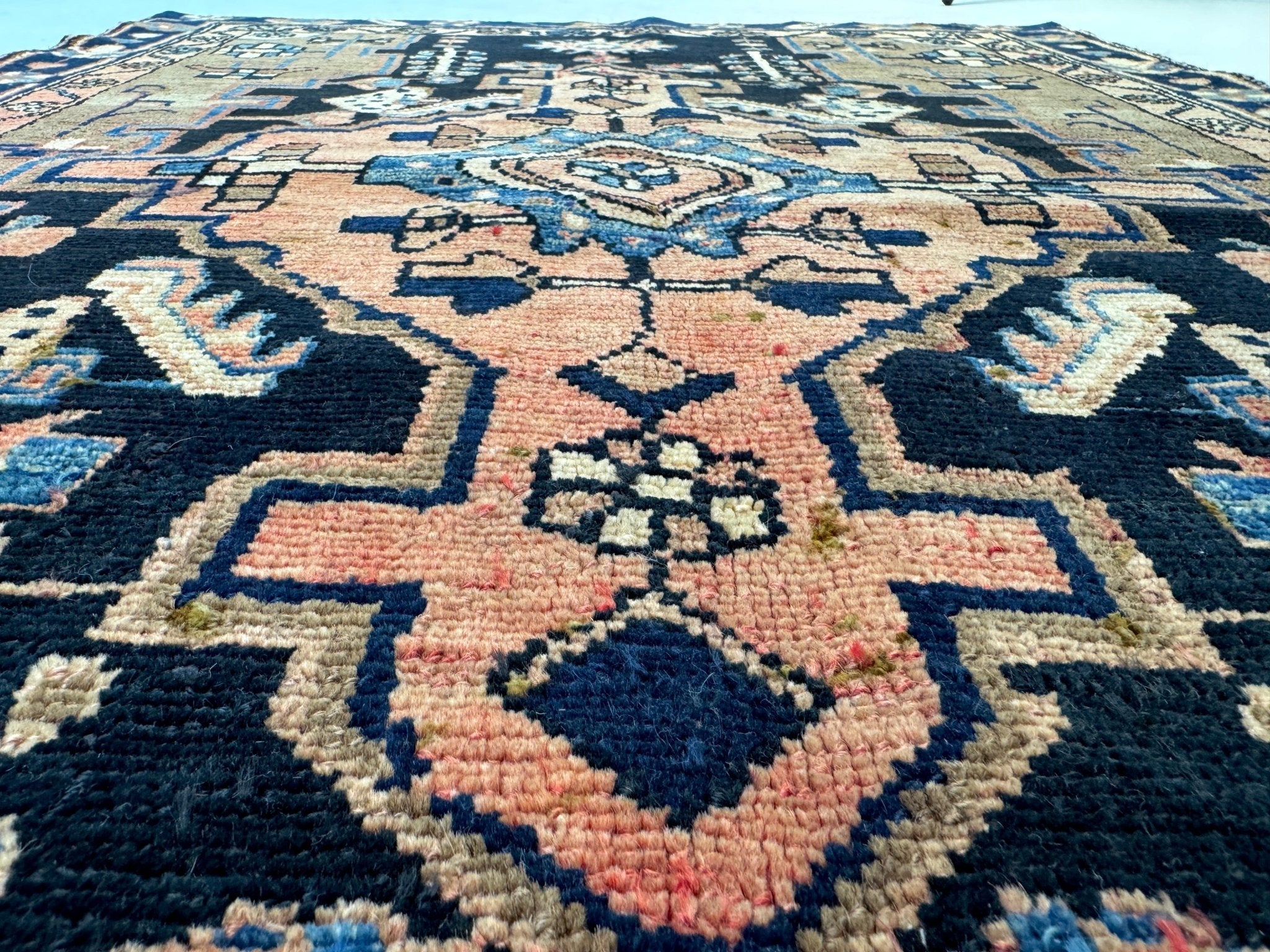 Hamadan rug close-up with navy, cream, and blue star motifs plus pink accents