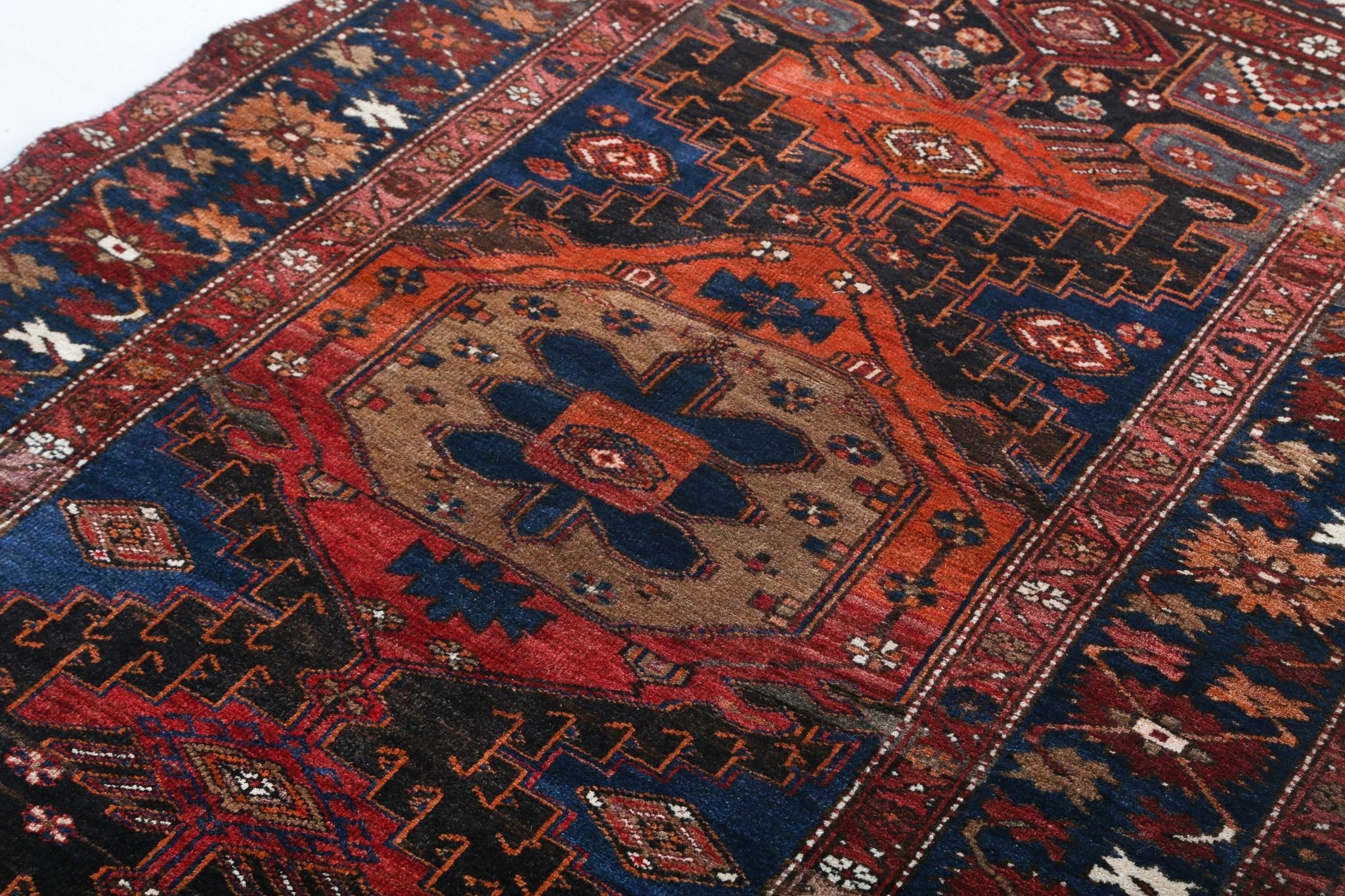 Persian Qoltuq rug close-up showing border diamonds and central medallion