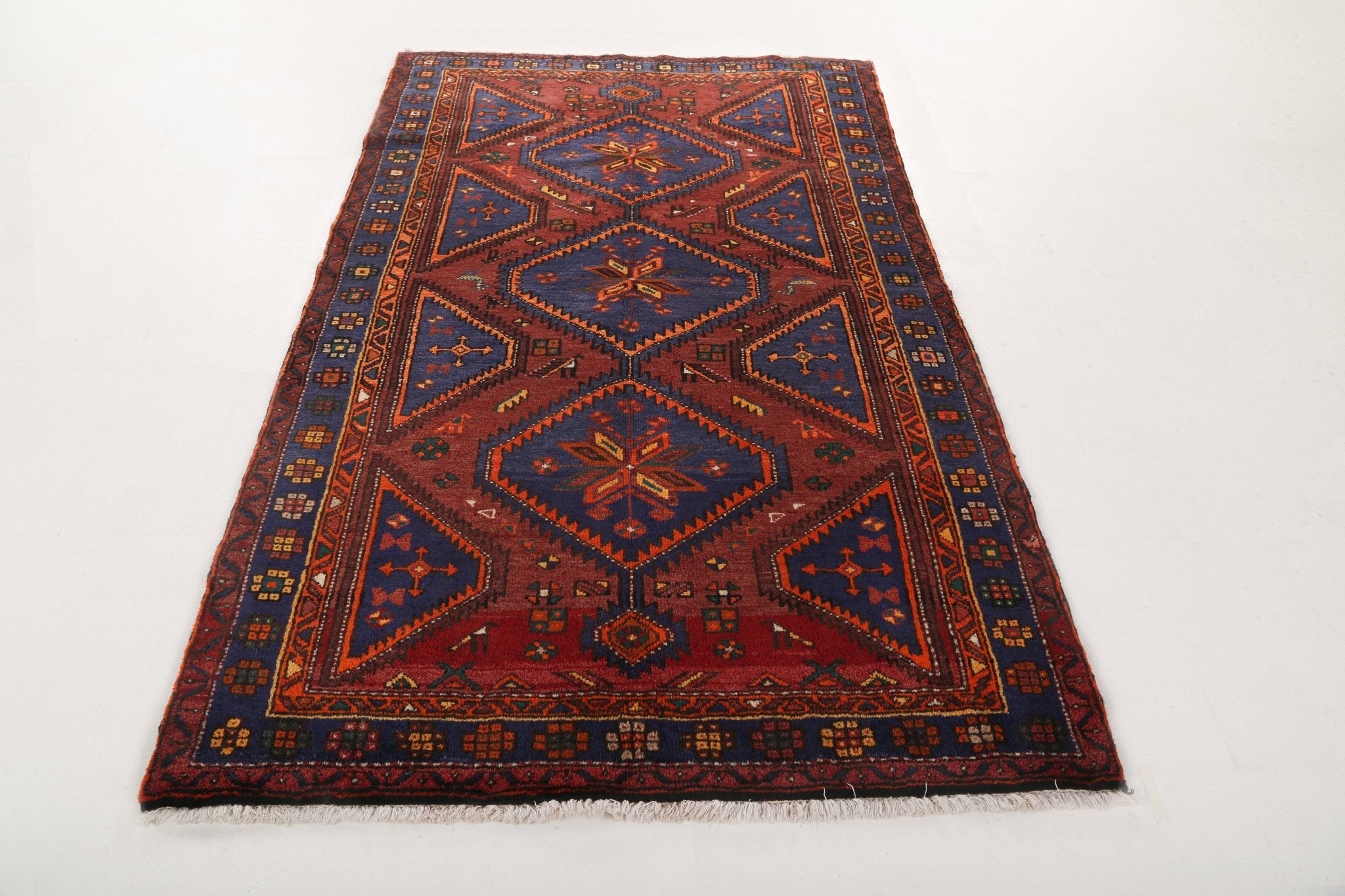 Hamadan Persian rug full view, rust and navy geometric medallion design