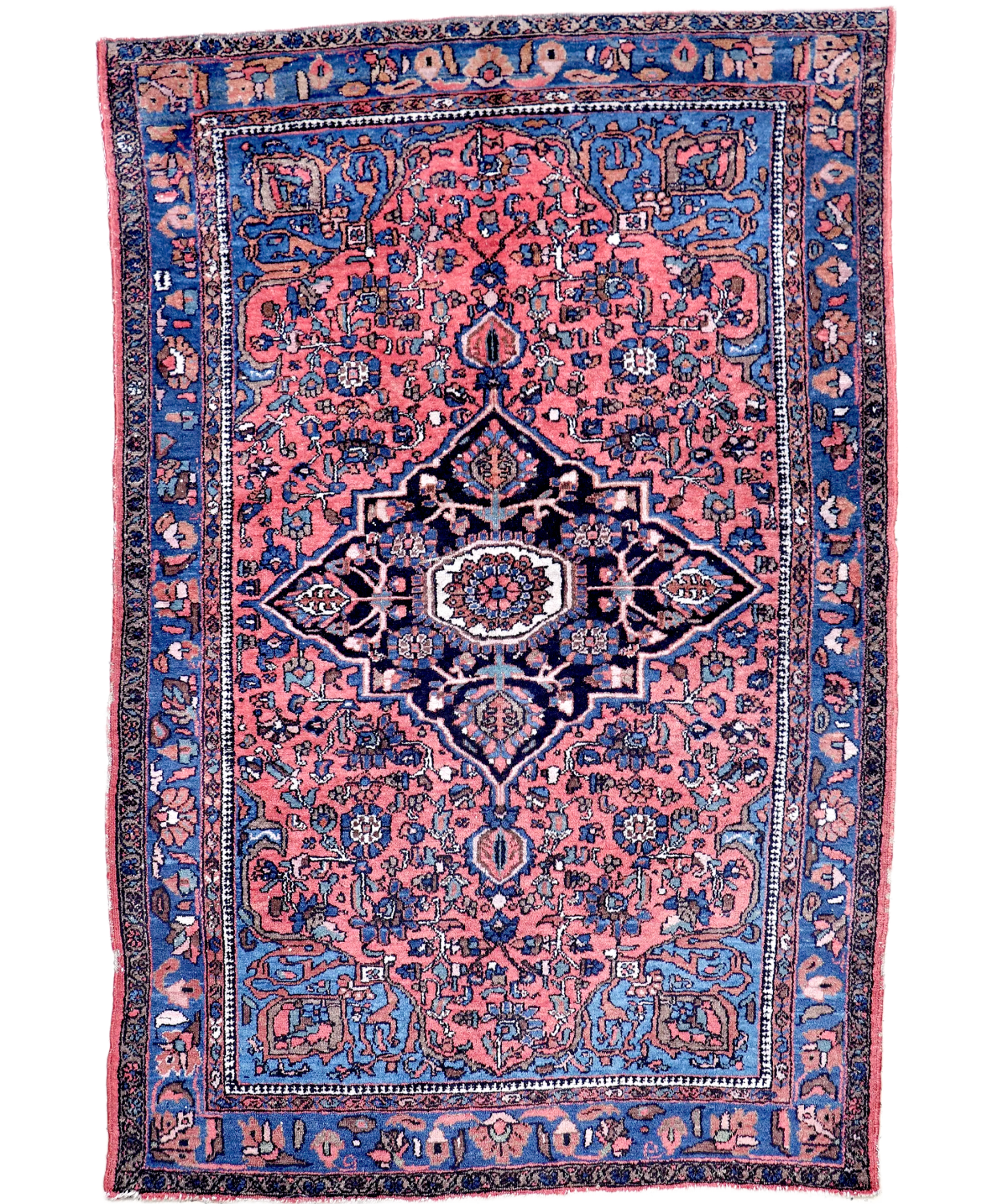 Hamadan-style Persian rug featuring a navy center medallion on a pink patterned field.