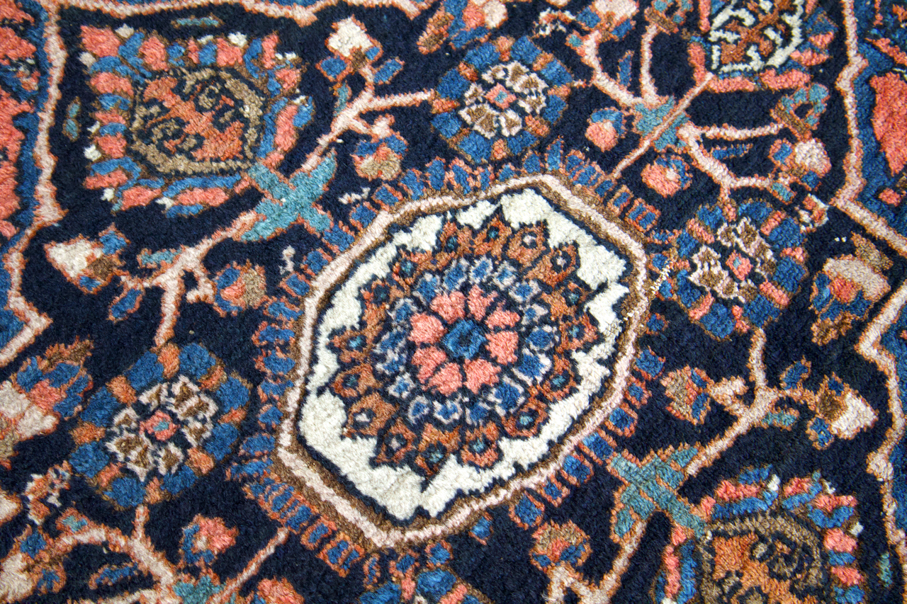 Persian Hamadan rug close-up of central medallion in blue and coral highlights