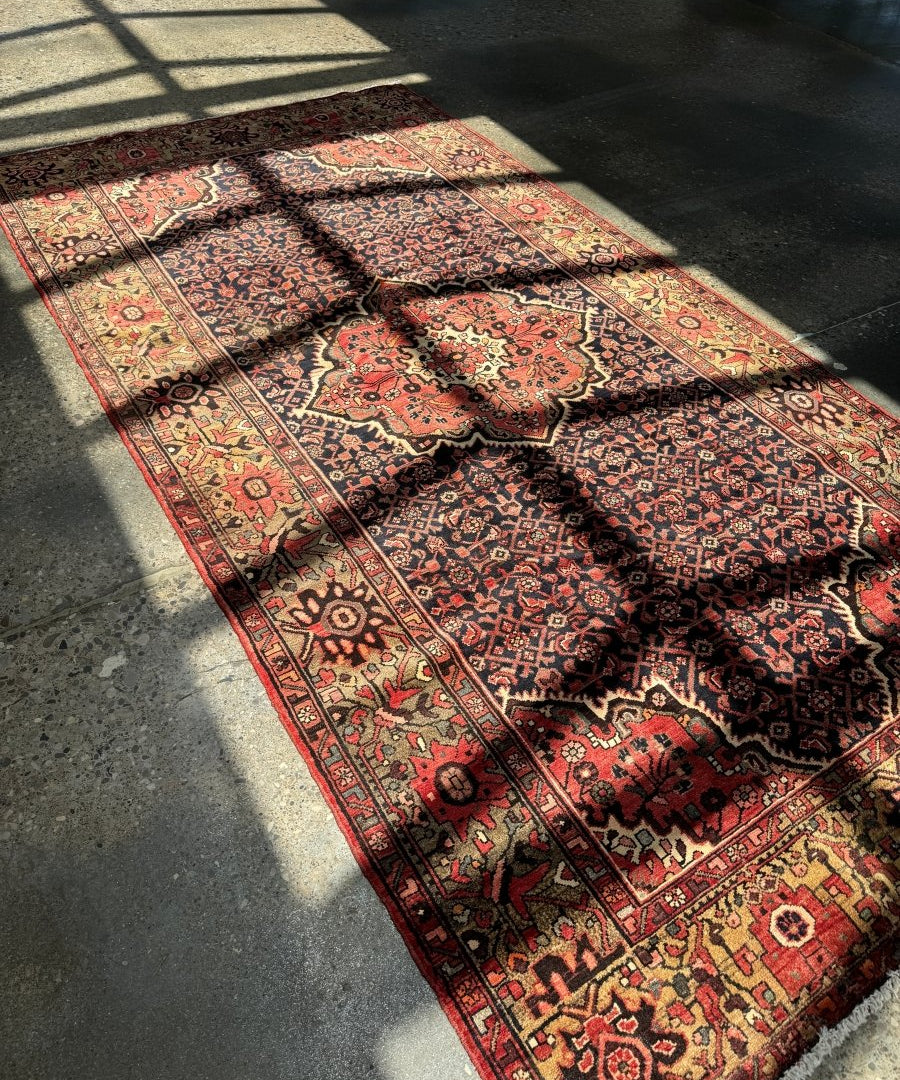 Persian Hamadan rug with navy center panel, red medallion, and ornate trims