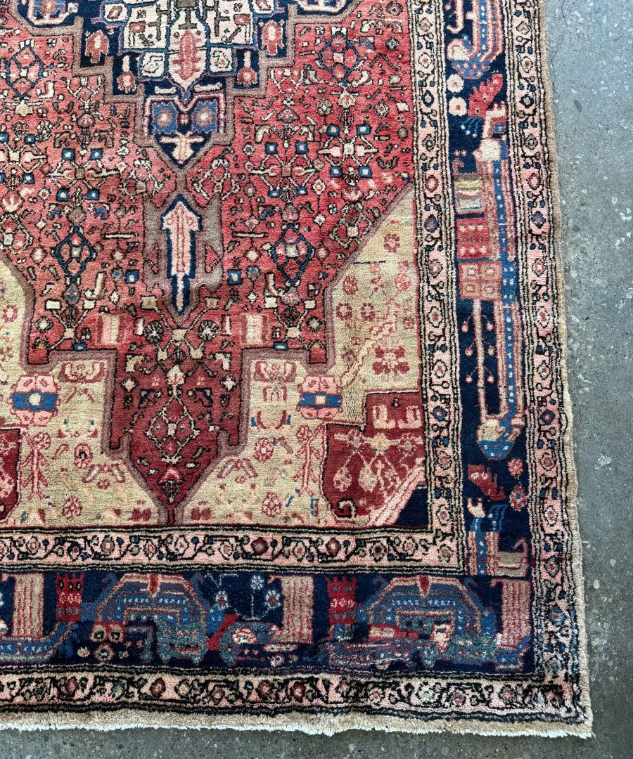 Close-up of Hamadan rug border with red and cream motifs on navy ground