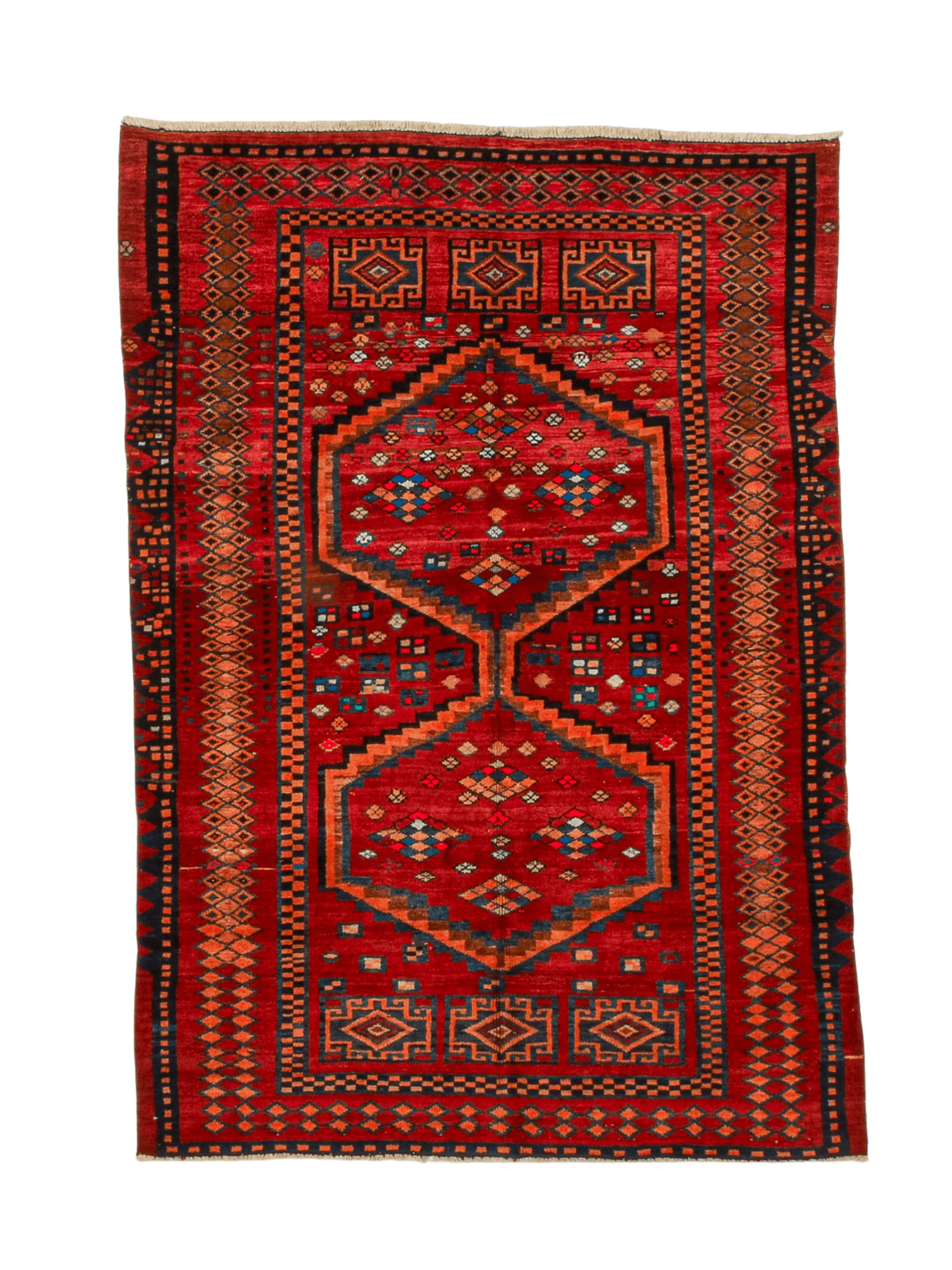 Red area rug with navy and orange stepped medallion pattern and cream fringe on edges.