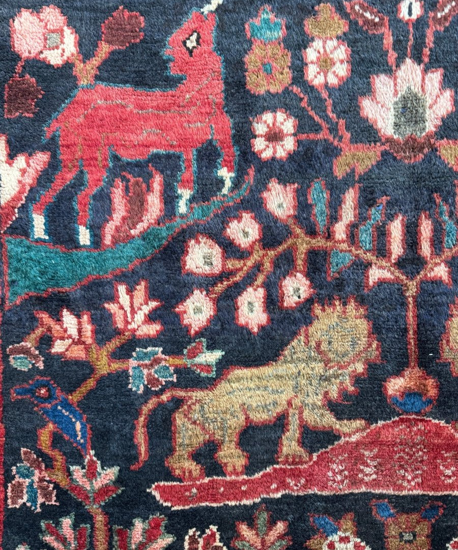 Runner rug close-up with dark navy background, red accents, and multicolor floral details