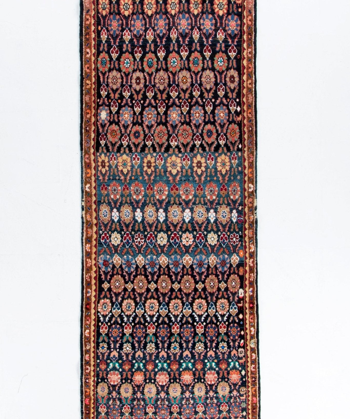 Hamadan runner rug with navy, rust, and teal medallion pattern, red border