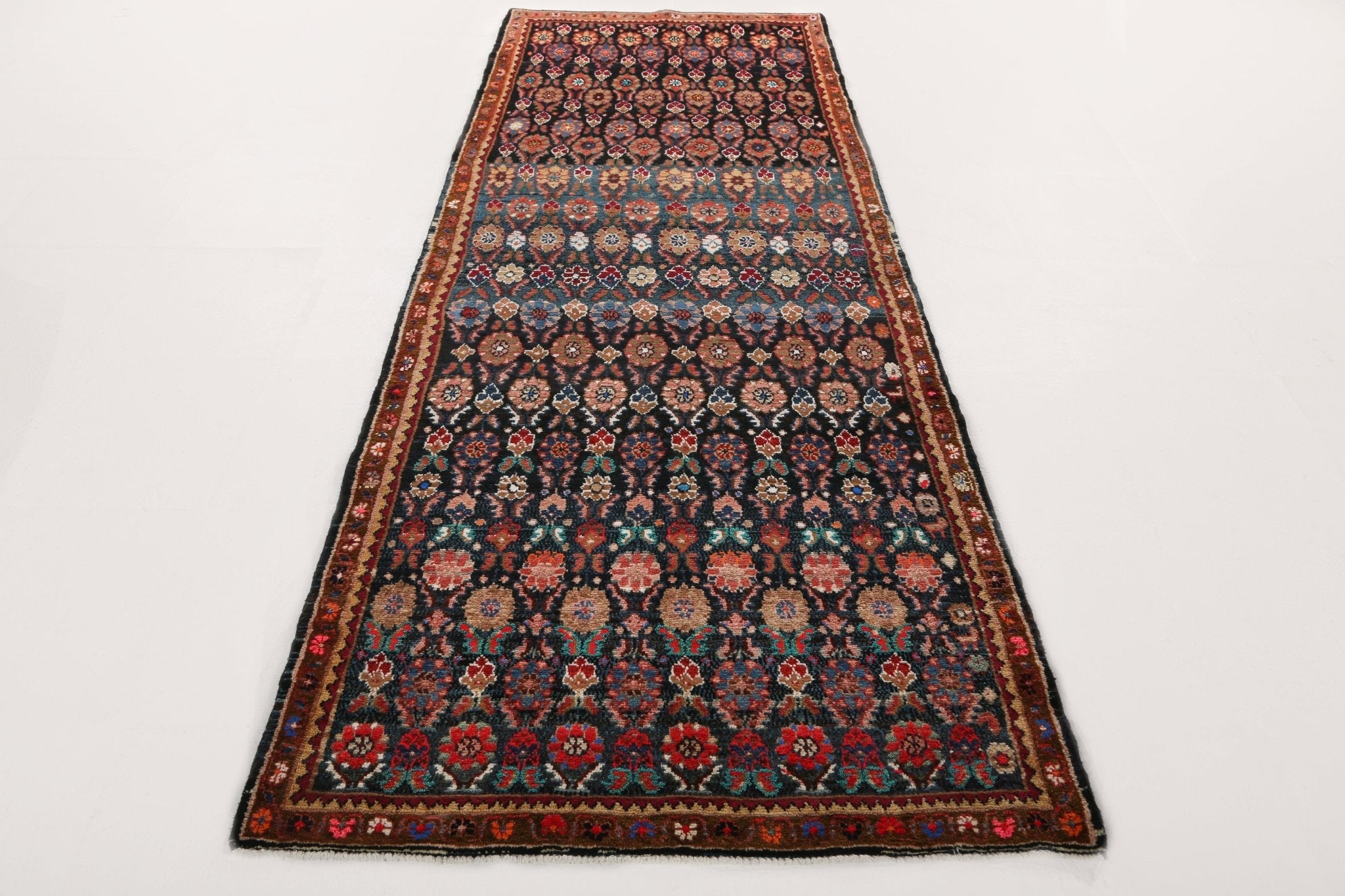 Persian Hamadan runner rug full view with dark navy background and red geometric floral details