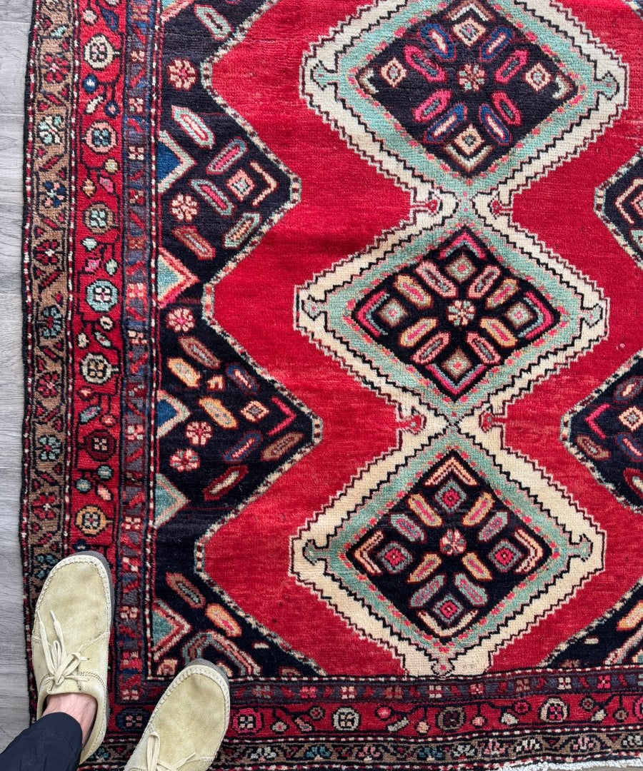 Persian Hamedan rug corner with red field, navy and cream geometric medallions