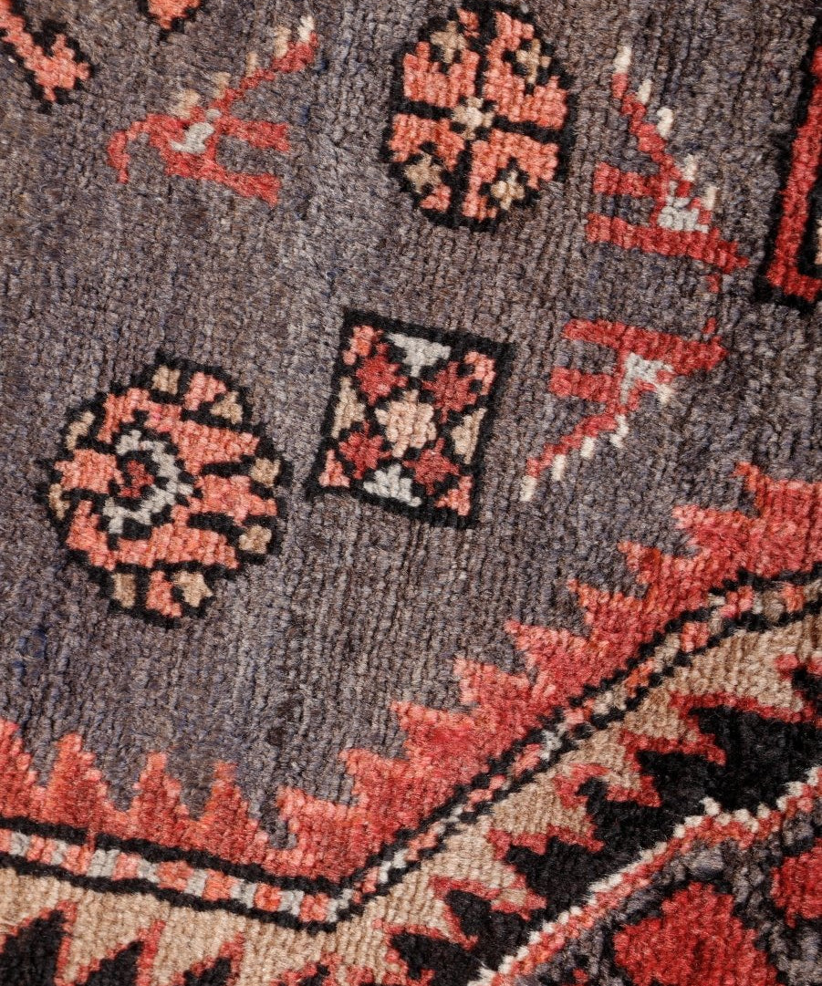 Persian Zanjan rug woven motifs on gray with red accents and black pattern shapes