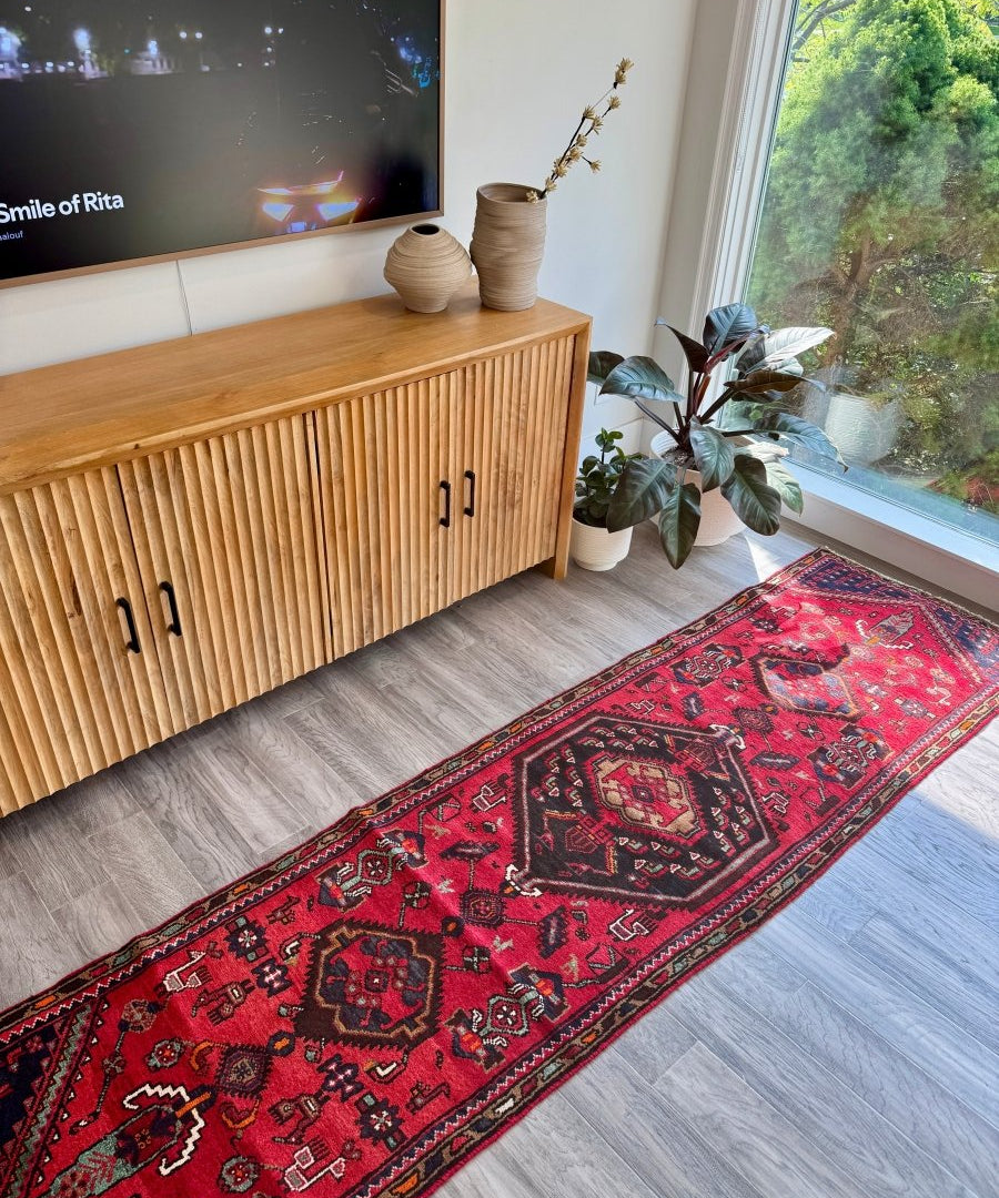 Red Persian Hamedan runner rug with dark blue and black medallion center and border pattern