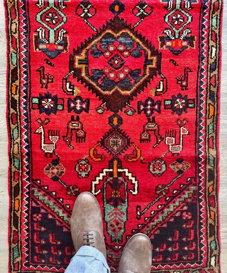 Red Persian Hamedan runner rug with navy and teal geometric motifs and central medallion