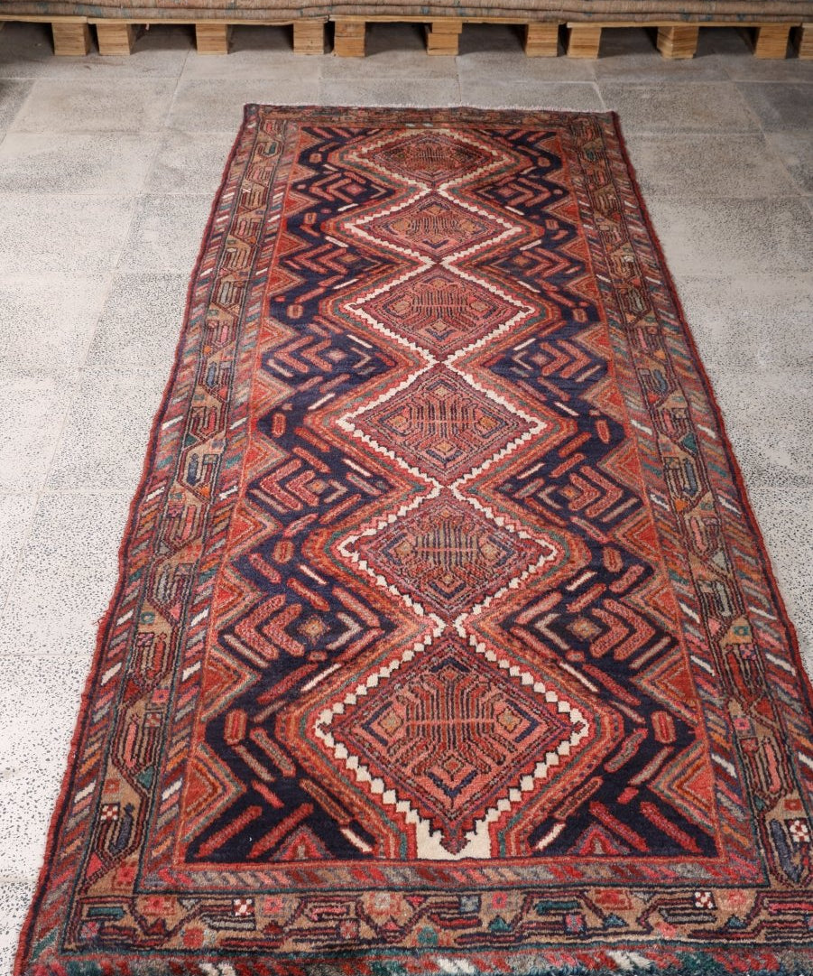 Persian Hamadan runner rug, navy with rust geometric diamonds and zigzag border