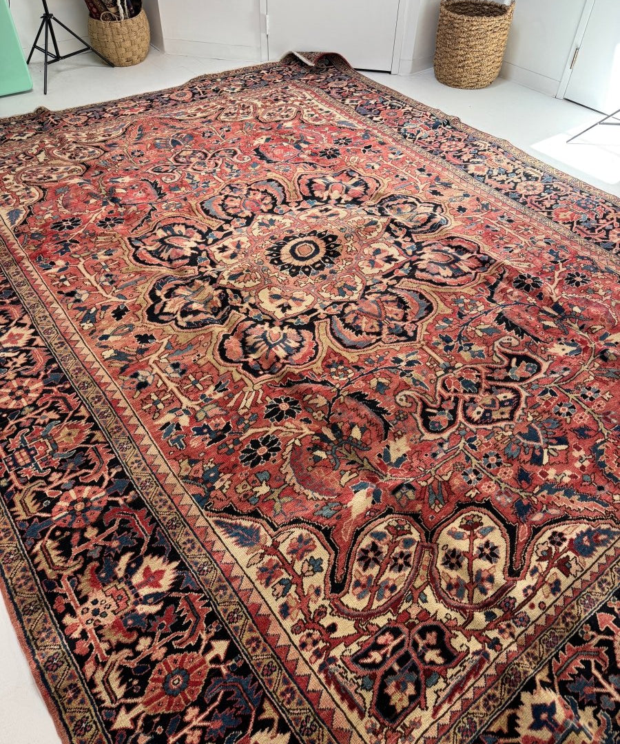 Persian Heriz rug large view with ornate central medallion, red ground and blue border