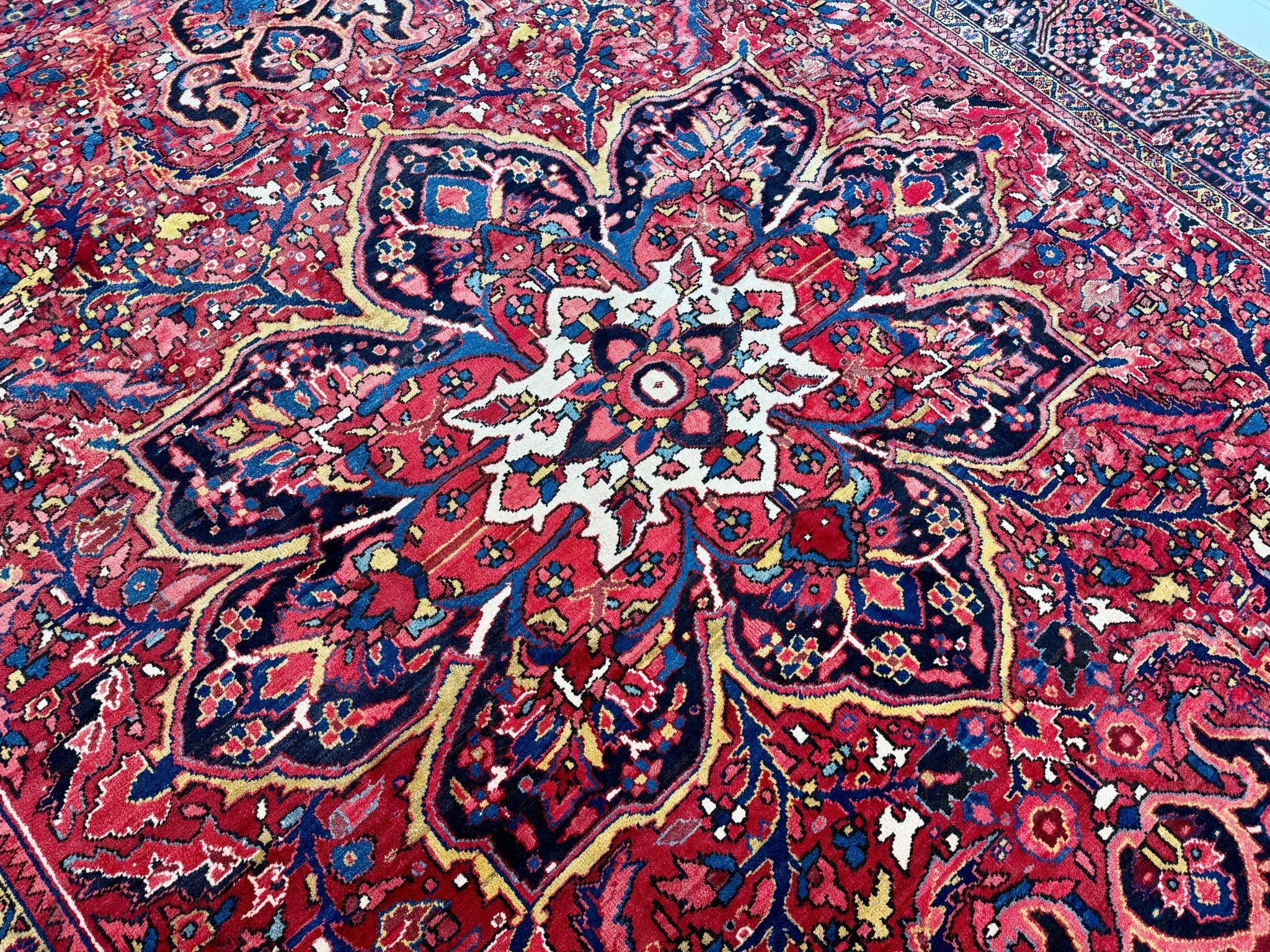 Persian Heriz rug close-up of ornate central floral design in red and blue tones