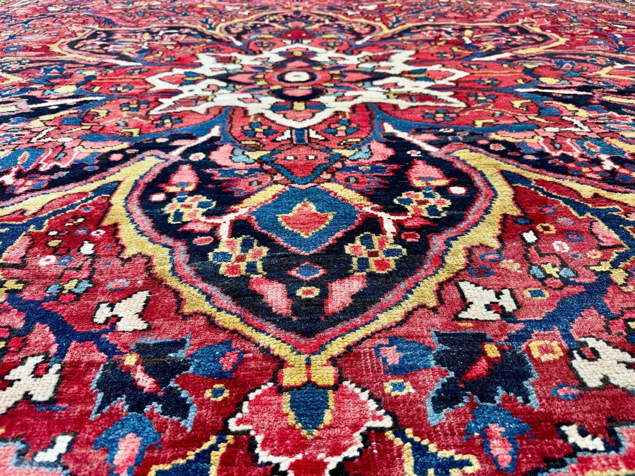 Persian Heriz rug close-up of central blue rosette with red and cream highlights
