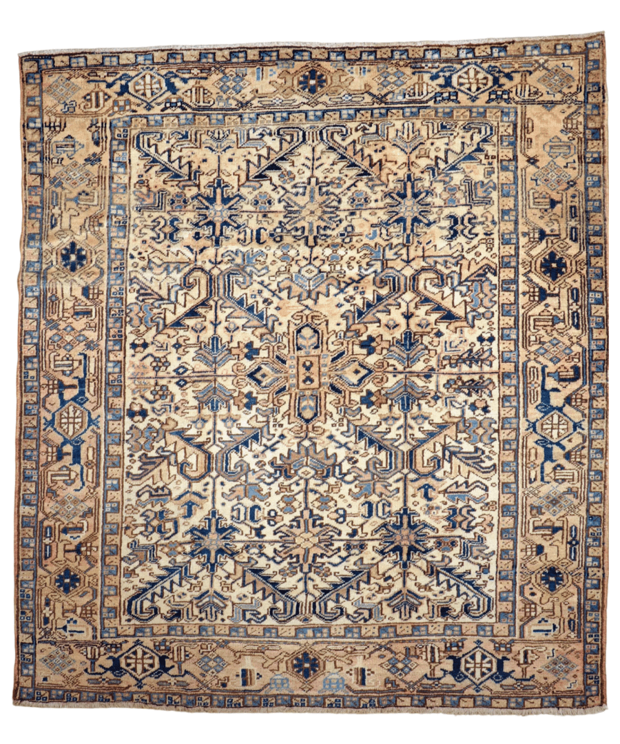 Persian Heriz rug flatlay with cream center medallion, blue motifs, and framed border