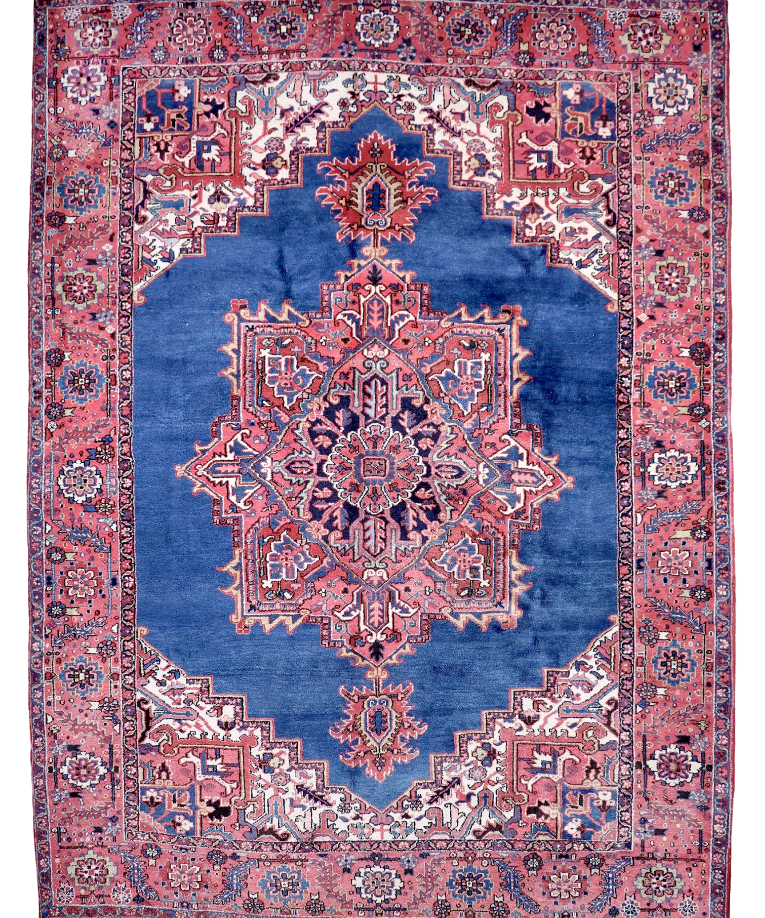 Persian Heriz rug, red and blue with central medallion, ornate geometric border.
