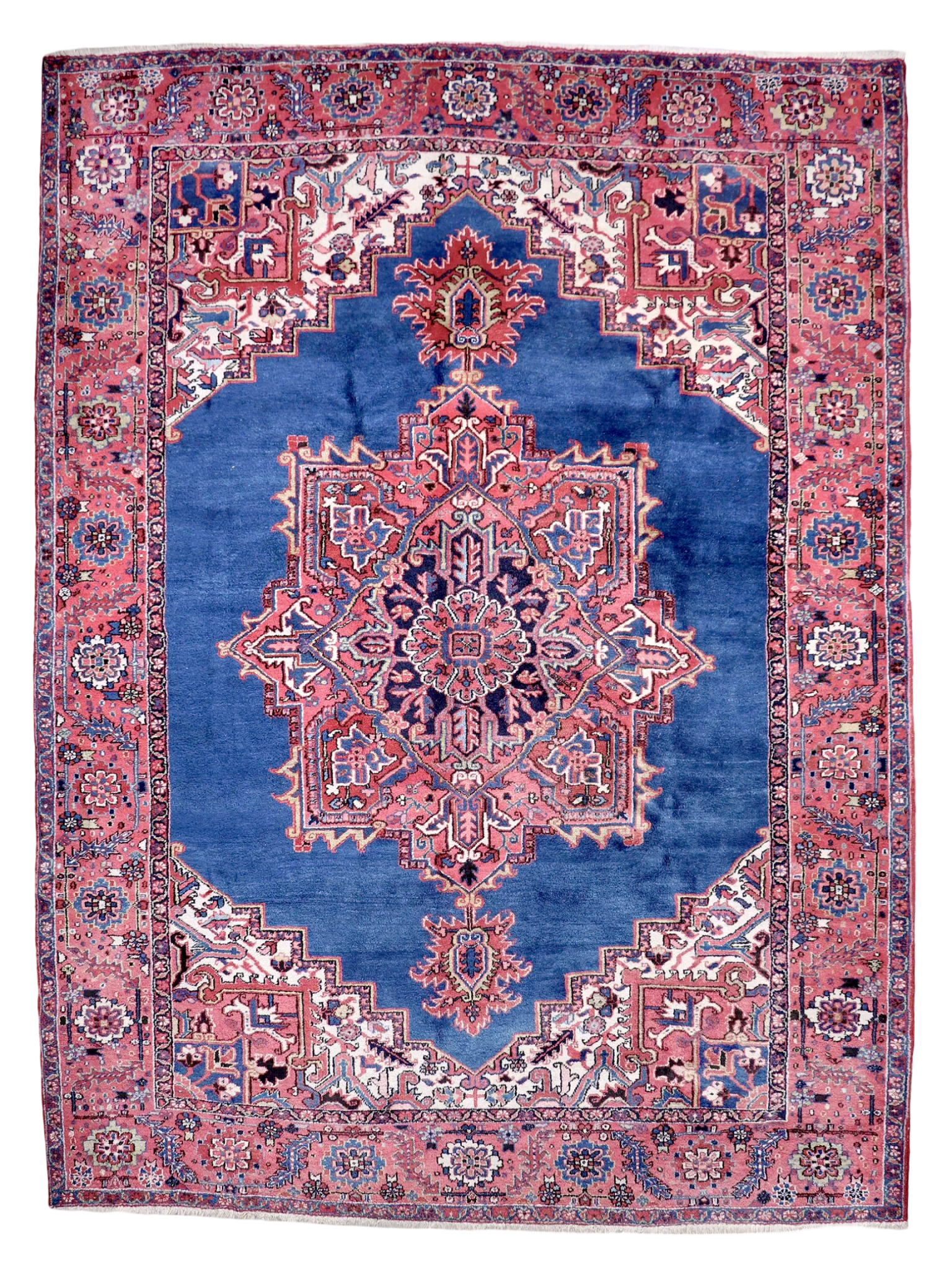 Persian Heriz rug, red and blue with central medallion, ornate geometric border.